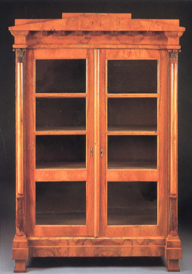 19th-Century AUSTRIAN, Biedermeier Black Walnut Bookcase, 1800-1825
ZZZ-MEDIA-FURNITURE, 78 x 51 5/8 x 20 1/2 in. (198.1 x 131.1 x 52.1 cm)
Peaked pediment and dentiled dornice above a pair of glazed cupboard doors opening to shelves flanked by collumnar supportw with acanthus-carved capitals and terminal raised on block feet
BIE-004-FU